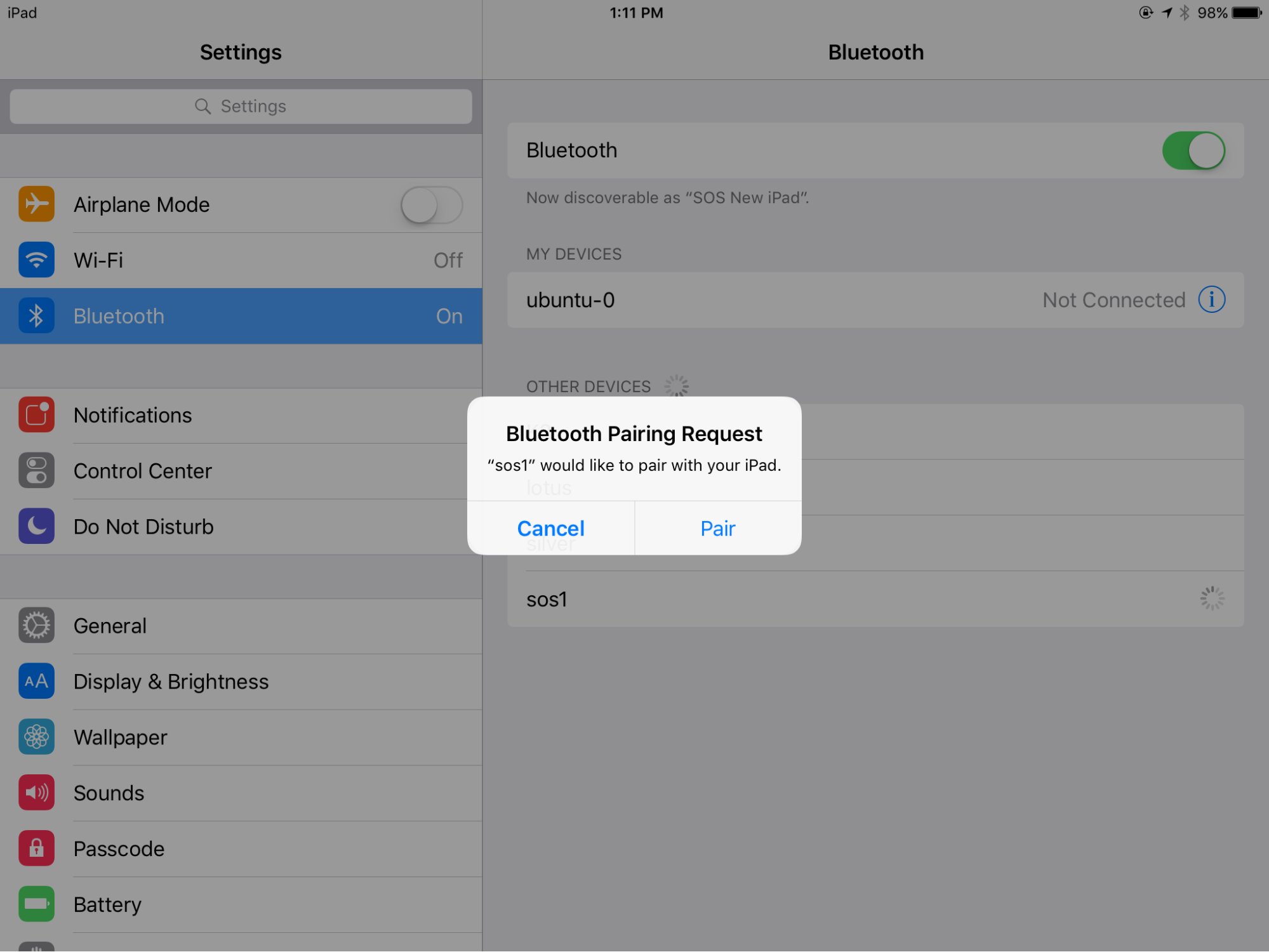 Screenshot of the iPad Bluetooth Pairing Request dialog reading sos1 would like to pair with your iPad
