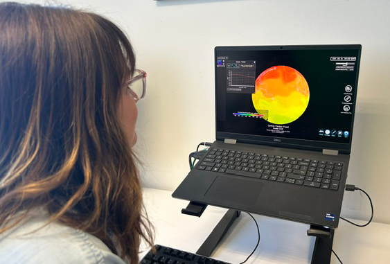 A person sits at a desk looking at a dataset of carbon dioxide
concentrations in SOS Explorer on a laptop computer screen.
